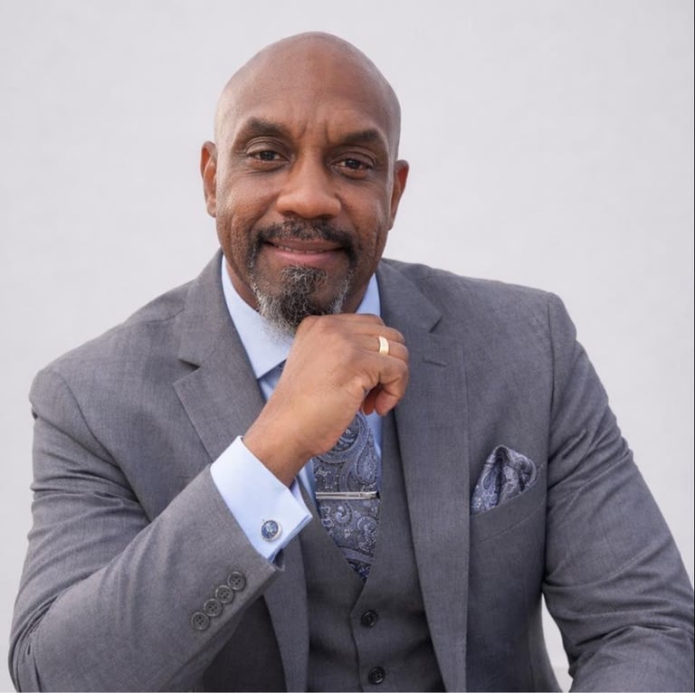 Professional headshot of Gary Bradfield, experienced notary public in gray suit and blue shirt, smiling confidently